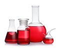 Set of laboratory glassware with red liquid on background Royalty Free Stock Photo