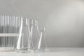 Set of laboratory glassware on white table against grey background, space for text Royalty Free Stock Photo