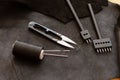Set of leather work tools on black leather. Workplace for shoemaker Royalty Free Stock Photo