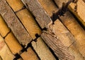 Set of light beige boards close-up part of a stack of diagonal row texture dried wood with a crack and grooves Royalty Free Stock Photo