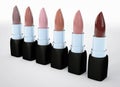 Set of lipsticks nude colors. Beige lipstick in a row isolated on white. 3d illustration of lipstick natural color. Royalty Free Stock Photo