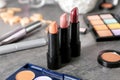 Set of lipsticks and other cosmetics on grey table Royalty Free Stock Photo