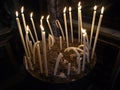 Set of long curved burning candles. Royalty Free Stock Photo