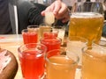 A set of lots of delicious yellow orange red glasses, shots with strong alcohol, vodka, brandy, brandy, beer on wooden Royalty Free Stock Photo