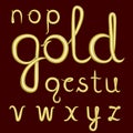 A set of lowercase Latin letters made of thick golden cream.