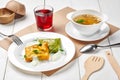 Set lunch of mushroom soup, spinach and carrot crepes with sour cream, berry drink Royalty Free Stock Photo