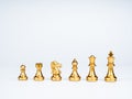 Set of luxury golden chess pieces isolated on white background.