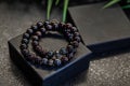 Set of luxury jewelry, black handmade bracelets made of natural stones and minerals. On black