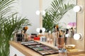 Set of luxury makeup products and accessories on dressing table with mirror. Royalty Free Stock Photo