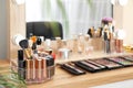 Set of luxury makeup products on dressing table with mirror. Royalty Free Stock Photo