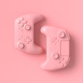 Set of lying gamer joysticks or gamepads on pink background