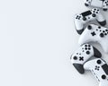 Set of lying gamer joysticks or gamepads on white background