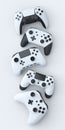 Set of lying gamer joysticks or gamepads on white background