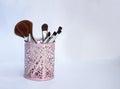 Set of makeup brushes in a pink iron glass