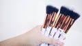 Makeup brushes in hand on a white background Royalty Free Stock Photo