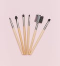 A set of makeup brushes with wooden handles on a pink background Royalty Free Stock Photo