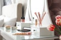 Set of makeup products and cosmetic brushes on dressing table. Interior design Royalty Free Stock Photo