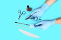 Set of manicure accessories on blue background top view. flat lay Manicure tool in the hands of the master. the concept of safe