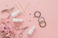 A set of manicure tools and accessories on a pink background with flowers and rhinestones. Nail care. Top view Royalty Free Stock Photo