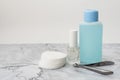 Set of manucure nail care products on a soft marble surface. Glass bottle with colorless firming nail polish, plastic bottle with Royalty Free Stock Photo