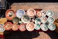 Set of many different bright handmade ceramic clay bowls, plates and jugs handpainted with floral and abstract patterns on sale Royalty Free Stock Photo