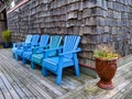 Set of blue chairs on a beachfront property patio on a clear day