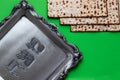 A set of matzah next to a silver tray with the words `matzah` written on it in Hebrew