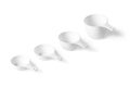 Set of measuring cups lined up, top view, white background Royalty Free Stock Photo