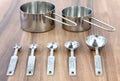 Set of measuring cups and measuring spoons use in cooking lay on dark brown table Royalty Free Stock Photo