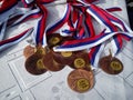 A set of medals from bronze, silver and gold for the Olympics. The main sports award of the athlete. Medals with ribbons are