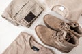 Set of men`s stylish clothes and shoes in beige colors on the table. Fashionable men`s spring-autumn clothes. Details trendy