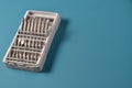 Set of metal bits for a screwdriver on a blue background Royalty Free Stock Photo