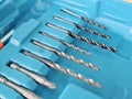 Set of metal drill bits arranged in a blue storage box for simple tool organization Royalty Free Stock Photo