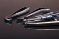 Set of metal medical equipment tools for teeth dental care on black mirror background. Selective focus. Royalty Free Stock Photo