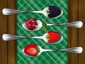 Set of metal spoons with berries.