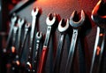 Wrench tools hanging on a textured wall with warm lighting creating shadows Royalty Free Stock Photo
