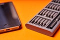 Set of miniature bits for screwdrivers and phone on an orange background Royalty Free Stock Photo