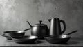Set of modern black cookware with kettle on grey background. Pans, pot create stylish kitchen. Minimalist design suits culinary Royalty Free Stock Photo