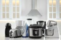 Set of modern home appliances on white table in kitchen Royalty Free Stock Photo