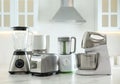 Set of modern home appliances on white table in kitchen Royalty Free Stock Photo