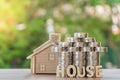 Set money Coin, shaped like a house ,house model, and house text. With green background, financial concept