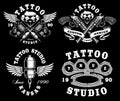 Set of monochrome tattoo emblems on dark background