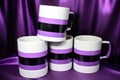 a set of mugs in the asexual pride flag colors