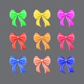 Set of multi-colored festive bows on a gray background. Royalty Free Stock Photo