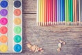 Creativity: Multi-colored pencils, water colors and brushes on rusty wooden table Royalty Free Stock Photo