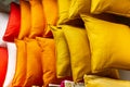 A set of multi-colored pillows in limbo in a supermarket.