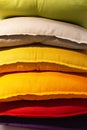 A set of multi-colored pillows in limbo in a supermarket.