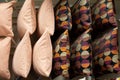 A set of multi-colored pillows in limbo in a supermarket.