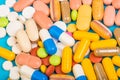 Set of multi-colored tablets and capsules on a blue background Royalty Free Stock Photo