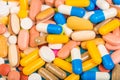Set of multi-colored tablets and capsules on a blue background Royalty Free Stock Photo